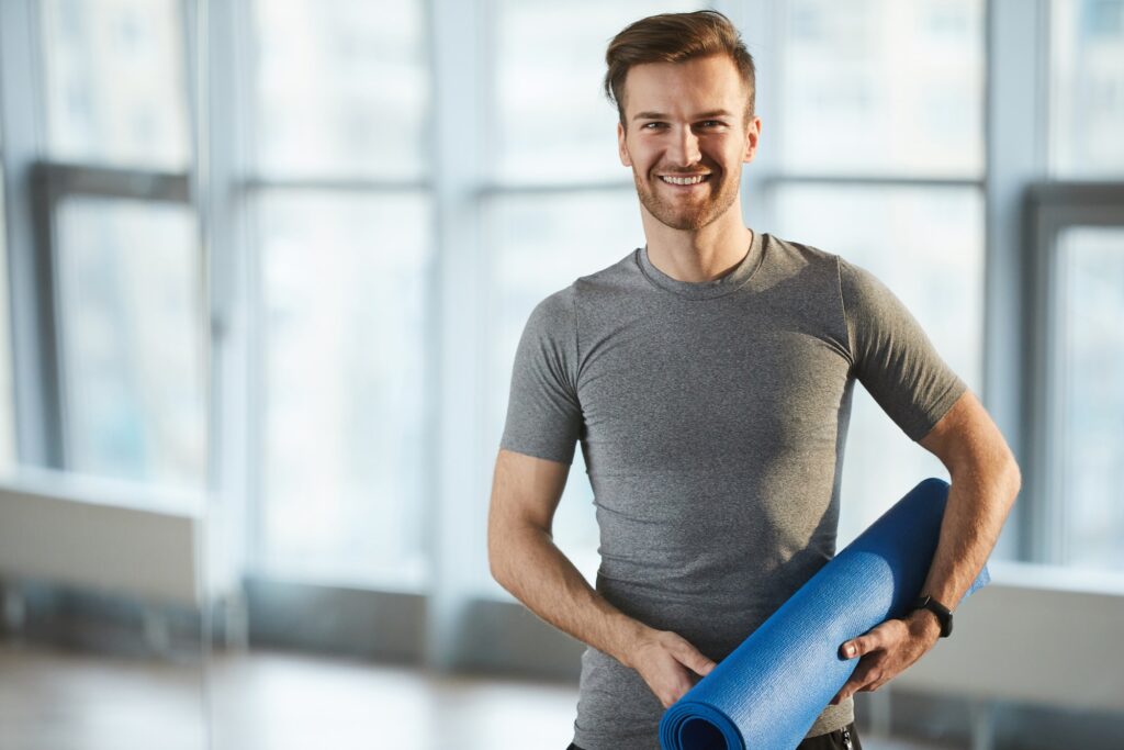 Young yoga coach in own studio